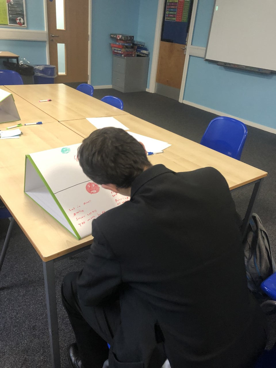 Special Educational Needs Department uses school tabletop whiteboard as a writing slope in lessons